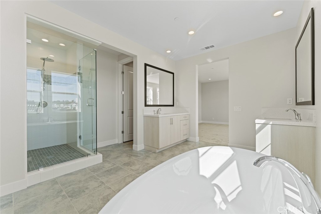 181 Hollyleaf Lake Forest, CA 92630 - Photo 24 of 36 a spacious bedroom with a bed and a sink