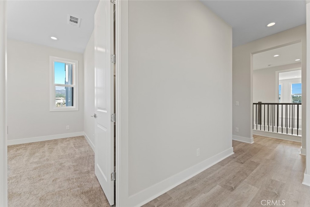 181 Hollyleaf Lake Forest, CA 92630 - Photo 31 of 36 an entryway of a room with wooden floor and windows
