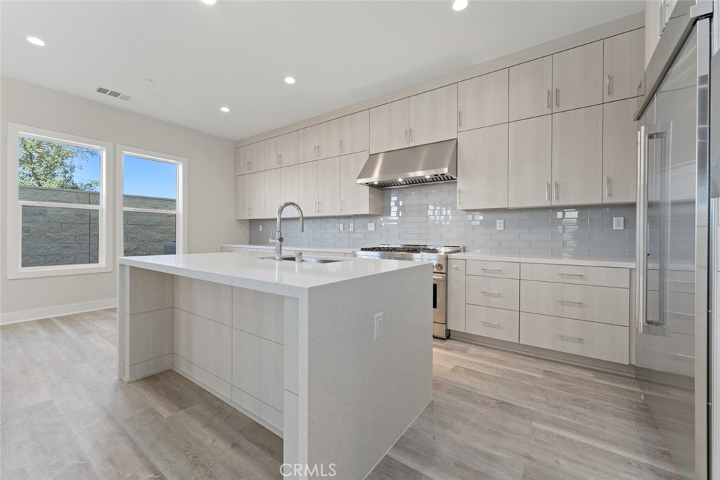 181 Hollyleaf Lake Forest, CA 92630 - Photo 8 of 36 a kitchen with white cabinets stove and sink