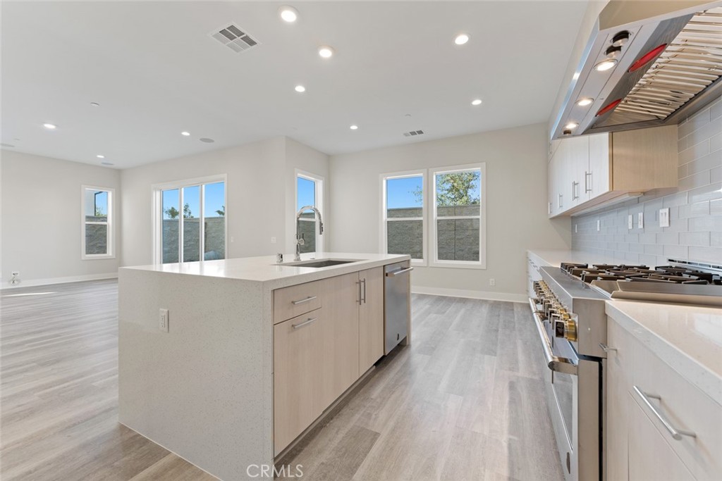 181 Hollyleaf Lake Forest, CA 92630 - Photo 10 of 36 a kitchen with granite countertop a stove and a sink