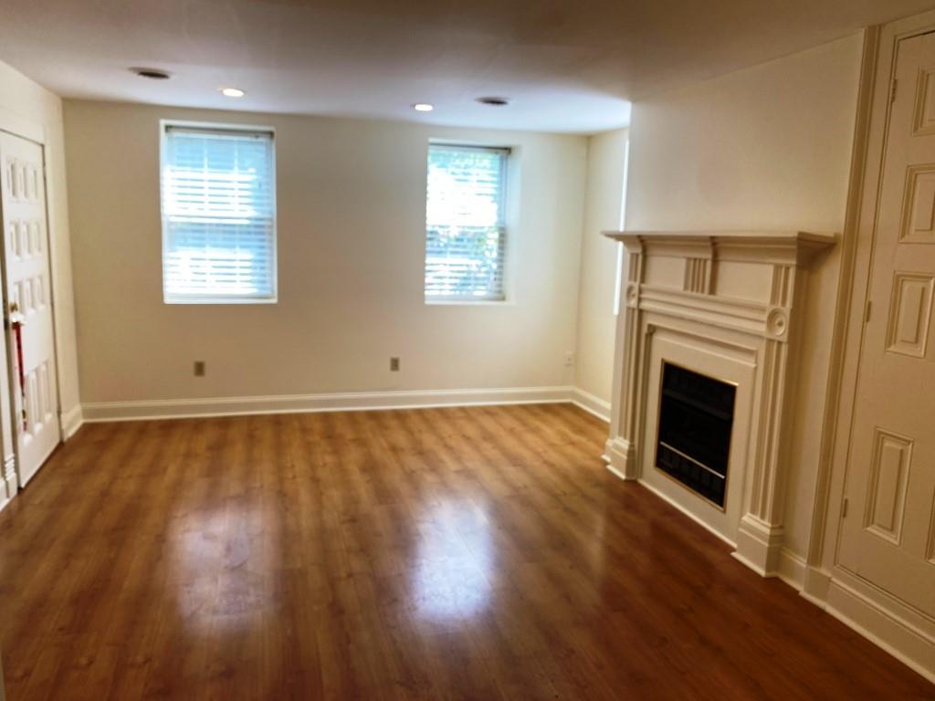 1319 Riverside Drive Beaver, PA 15009 - Photo 14 of 49 an empty room with wooden floor fireplace and windows