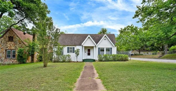 a front view of house with yard and green space