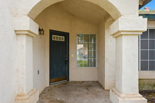 a view of a livingroom with wooden floor and a window
