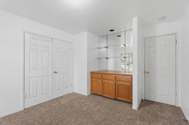 a room with closet and wooden door