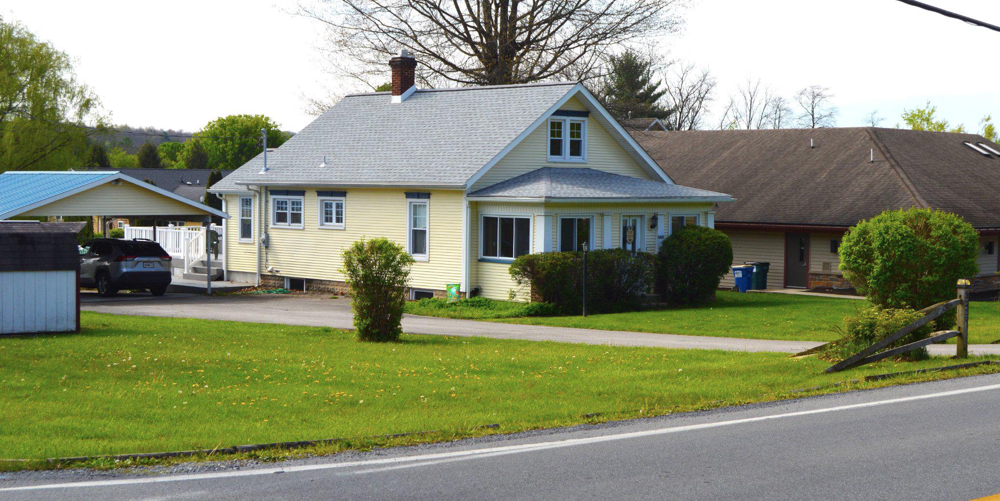 a front view of a house with garden