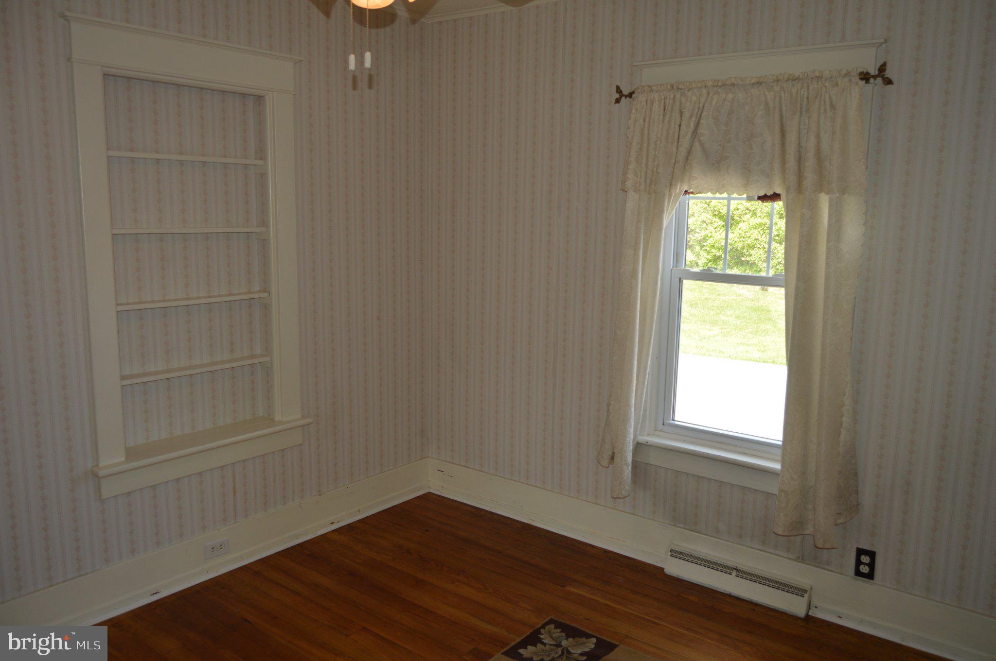 3225 Cold Springs Road Huntingdon, PA 16652 - Photo 24 of 40 a view of an empty room with a window and wooden floor