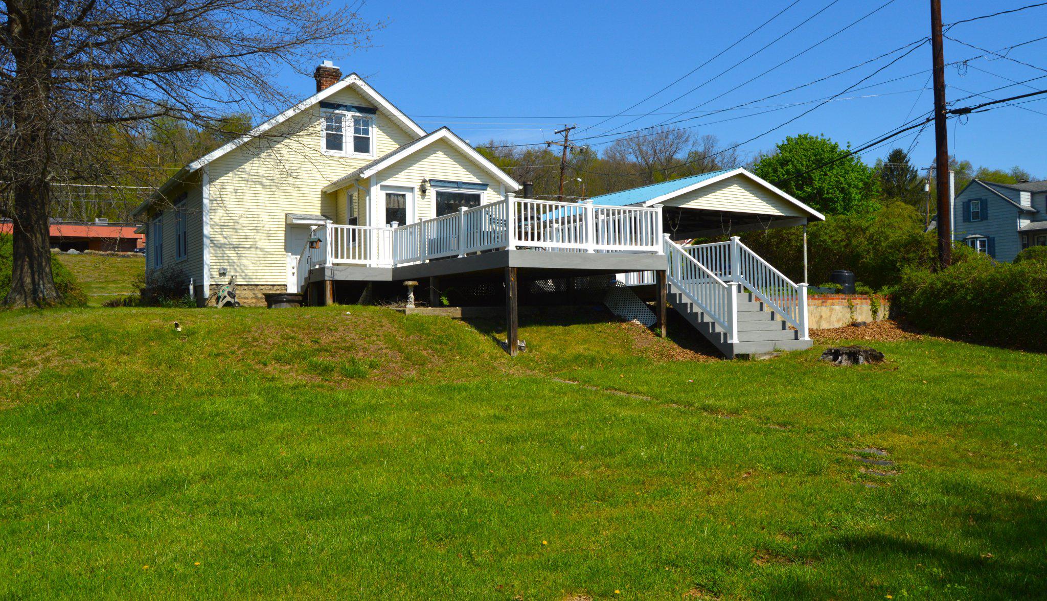 3225 Cold Springs Road Huntingdon, PA 16652 - Photo 38 of 40 a front view of a house with a yard table and chairs