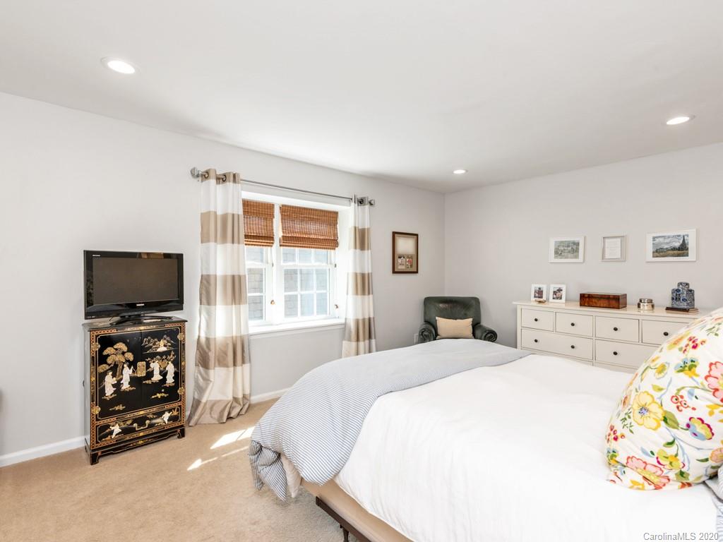 3516 Colony Road, Unit A Charlotte, NC 28211 - Photo 14 of 29 a room with a bed a television and a window