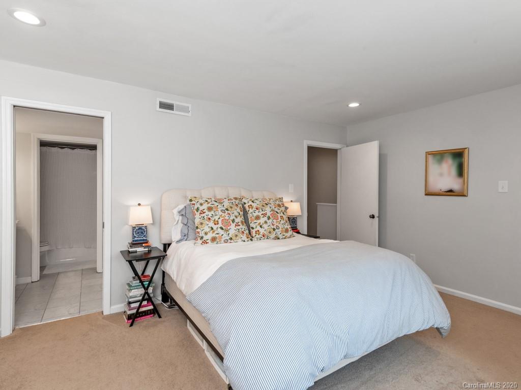 3516 Colony Road, Unit A Charlotte, NC 28211 - Photo 15 of 29 a bedroom with a bed and a mirror