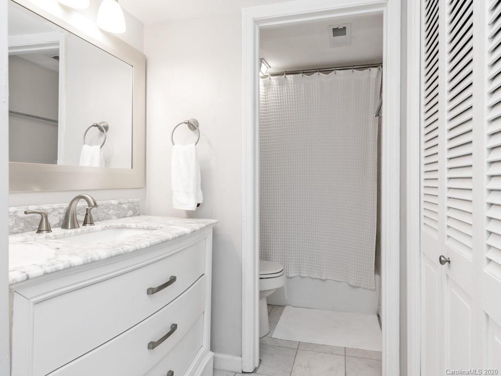 3516 Colony Road, Unit A Charlotte, NC 28211 - Photo 16 of 29 a bathroom with a granite countertop sink toilet and shower
