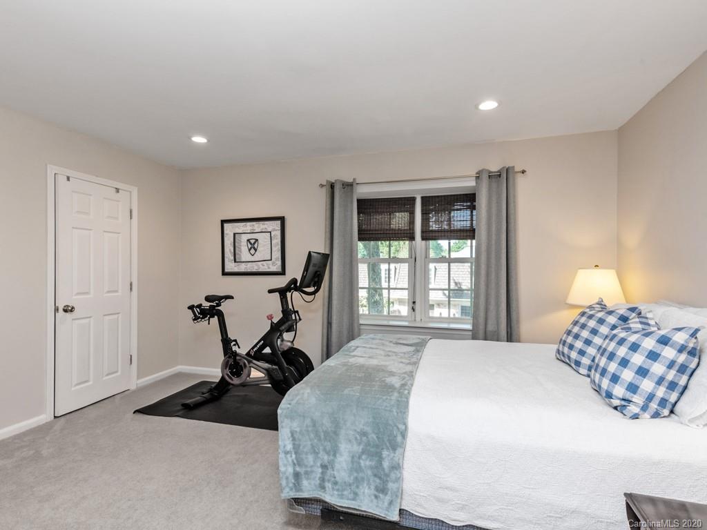 3516 Colony Road, Unit A Charlotte, NC 28211 - Photo 18 of 29 a bed room with a bed and a chair