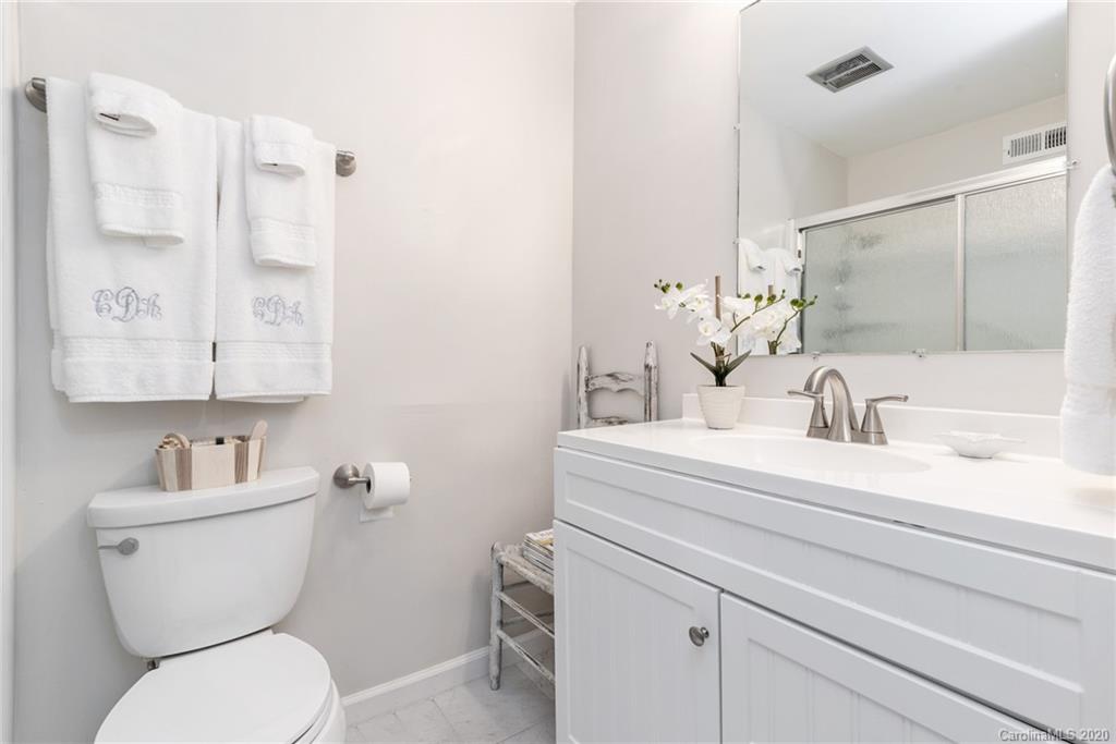 3516 Colony Road, Unit A Charlotte, NC 28211 - Photo 19 of 29 a bathroom with a toilet sink and mirror