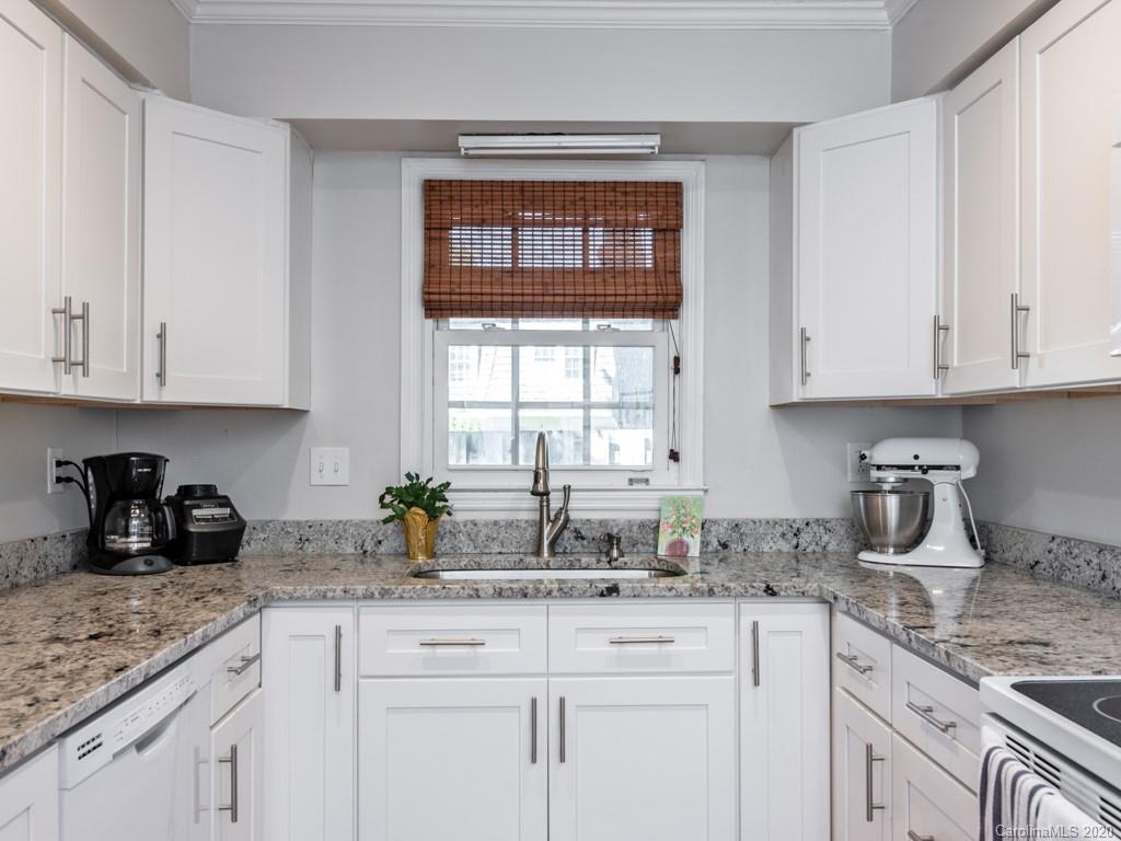 3516 Colony Road, Unit A Charlotte, NC 28211 - Photo 7 of 29 a kitchen with stainless steel appliances granite countertop white cabinets sink and window