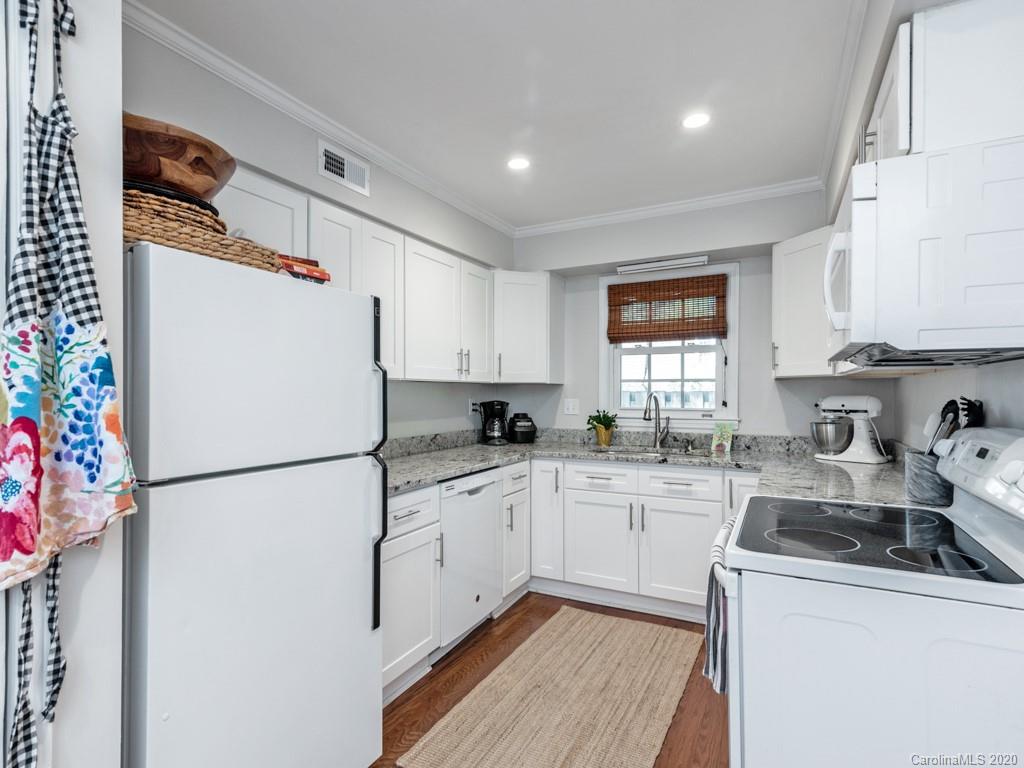 3516 Colony Road, Unit A Charlotte, NC 28211 - Photo 8 of 29 a kitchen with granite countertop a refrigerator a sink a stove a dining table and chairs