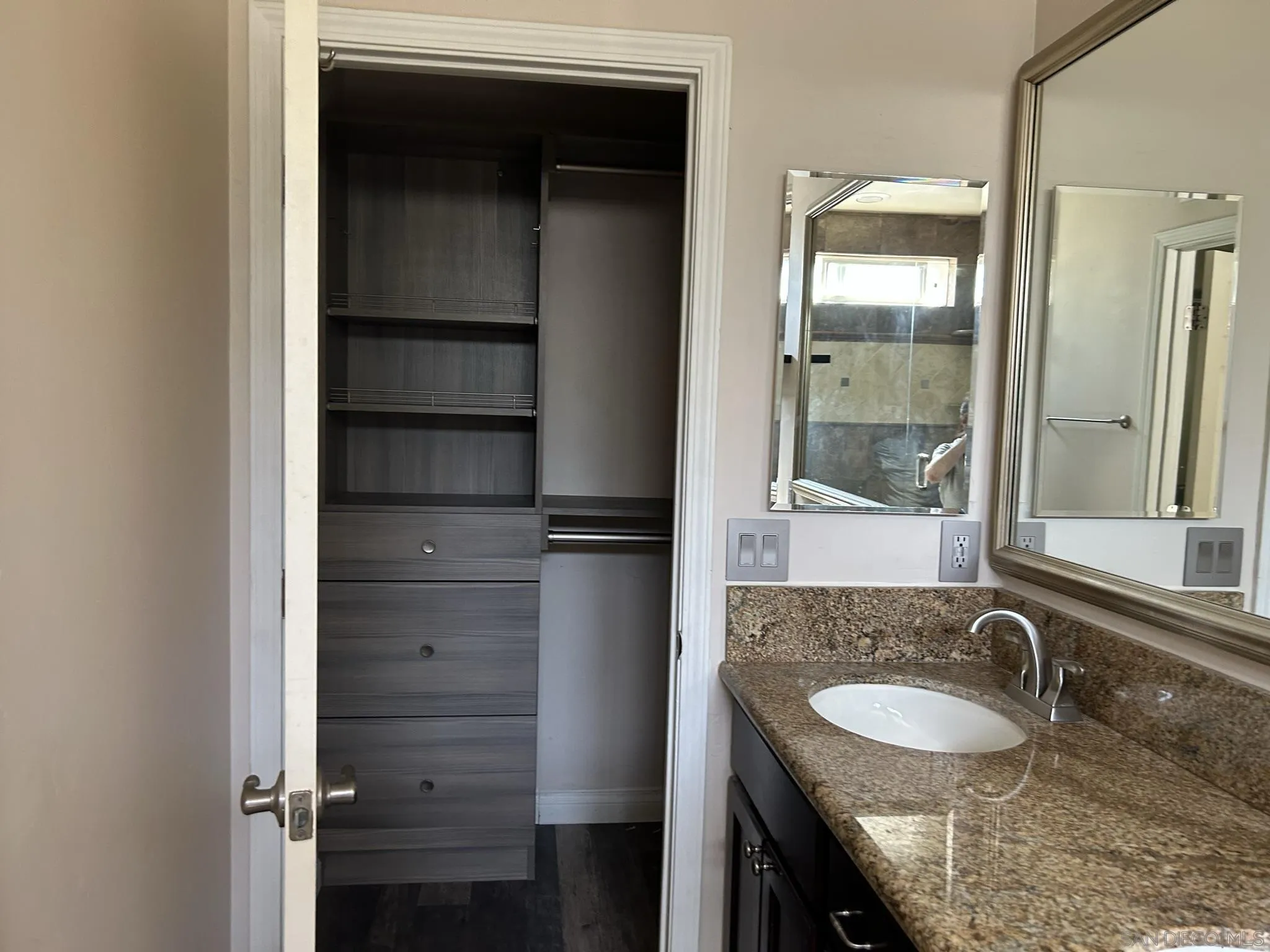 15408 Espola Road Poway, CA 92064 - Photo 20 of 27 a bathroom with a granite countertop sink and a mirror