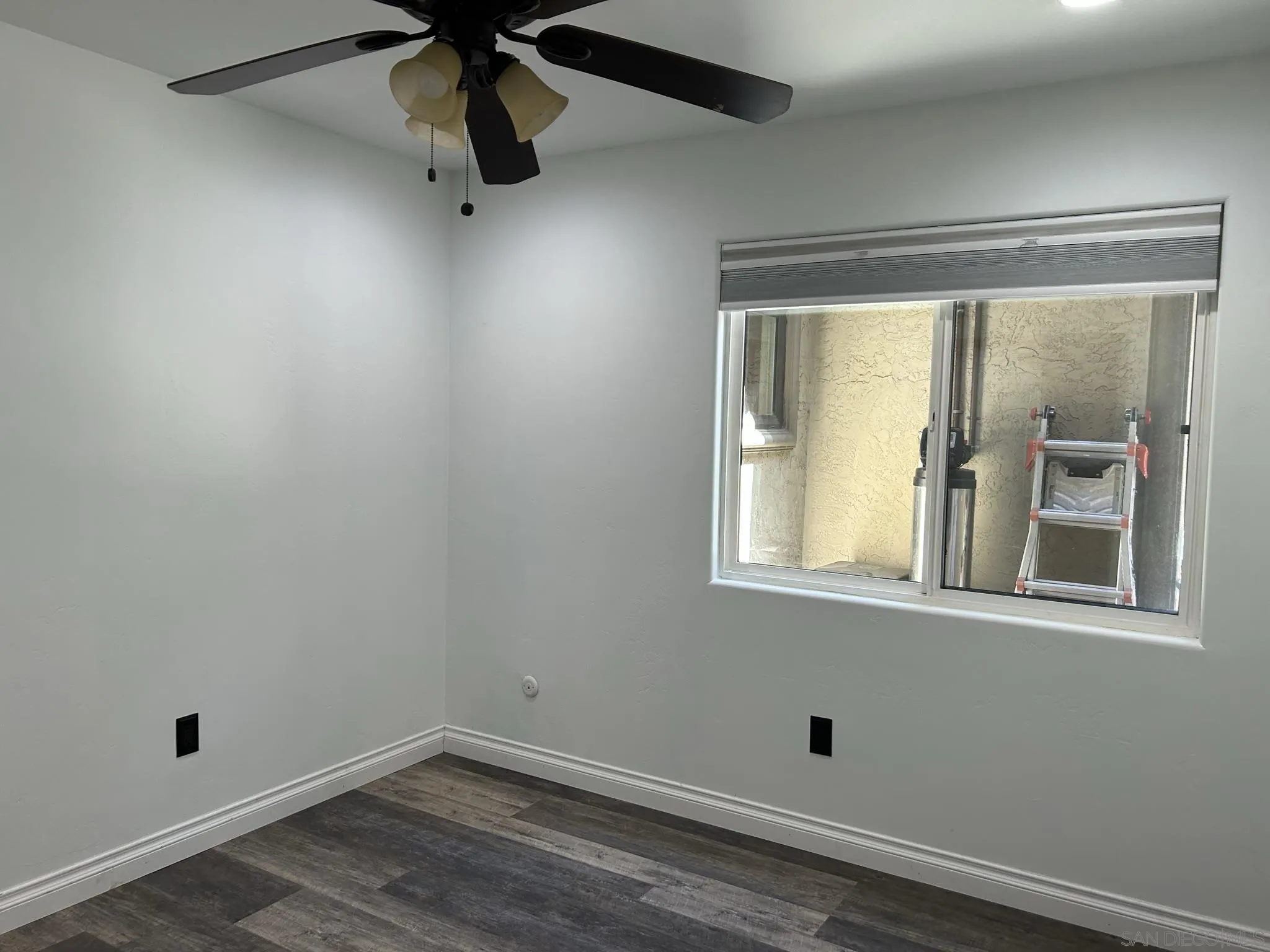 15408 Espola Road Poway, CA 92064 - Photo 22 of 27 an empty room with wooden floor and windows