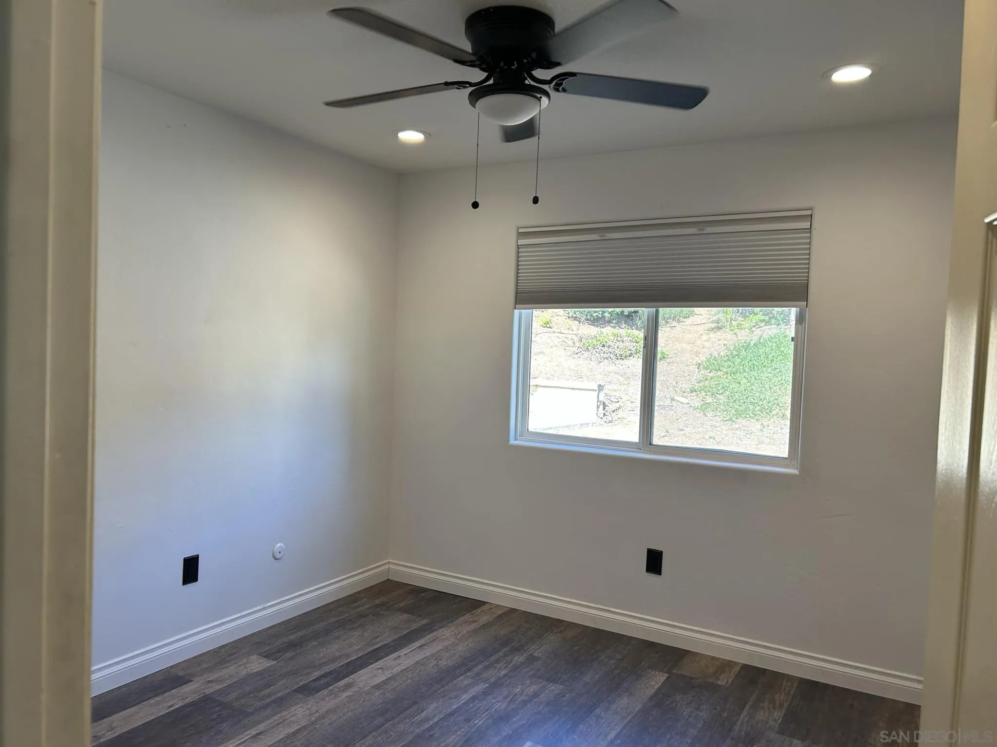 15408 Espola Road Poway, CA 92064 - Photo 23 of 27 an empty room with a window and a ceiling fan