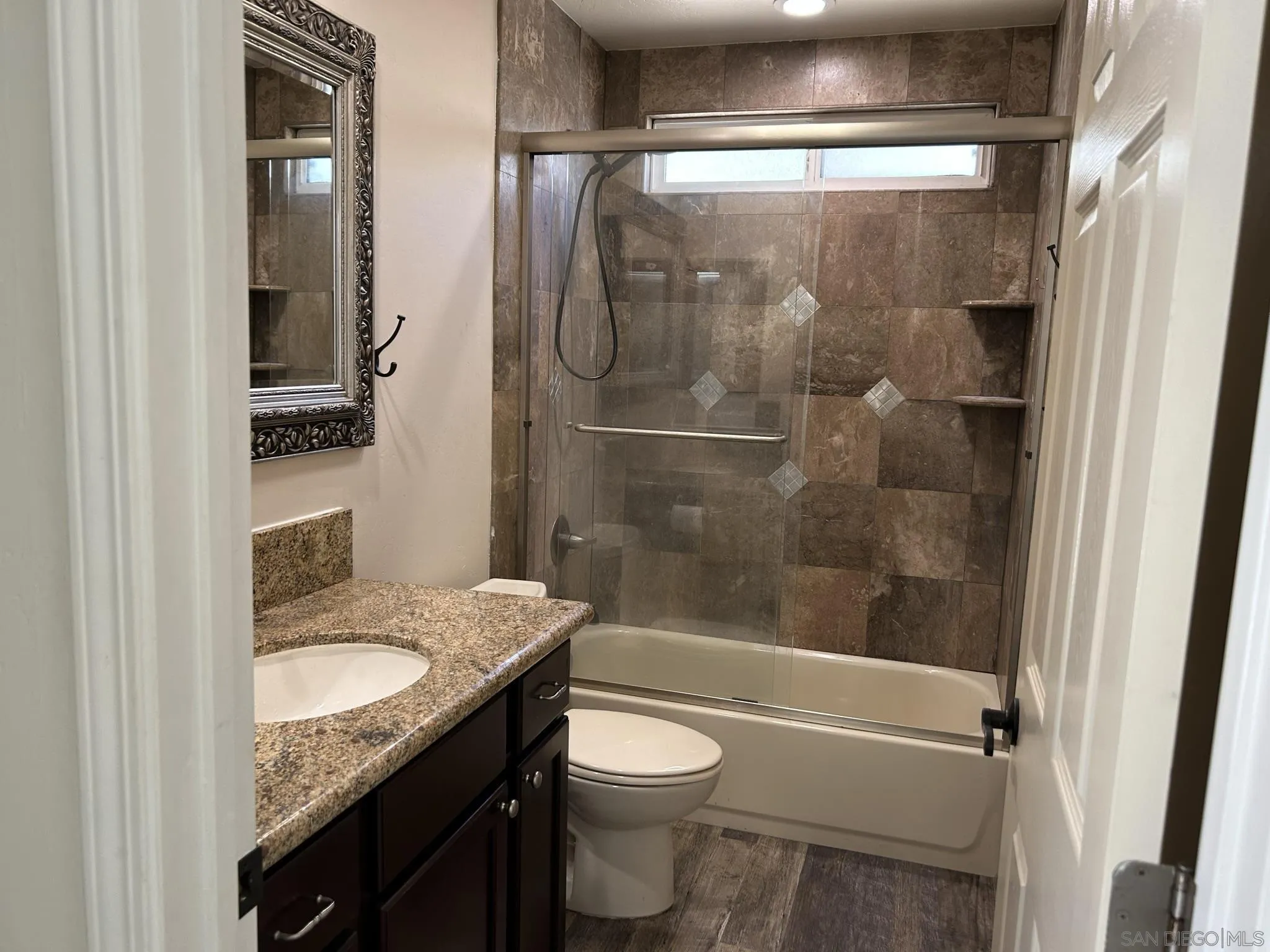 15408 Espola Road Poway, CA 92064 - Photo 25 of 27 a bathroom with a granite countertop sink toilet and shower
