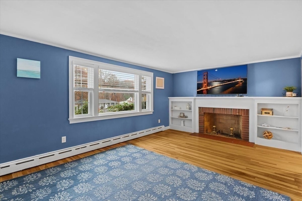 100 Whiting Street Hingham, MA 02043 - Photo 20 of 34 a view of empty room with a fireplace and windows