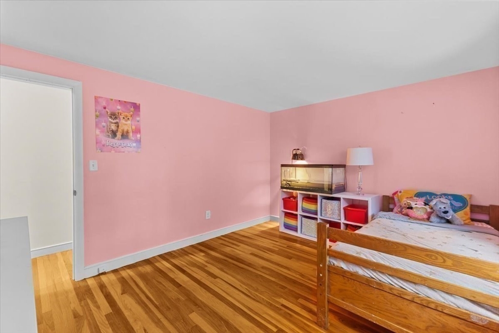 100 Whiting Street Hingham, MA 02043 - Photo 27 of 34 a room with a bed and a chandelier