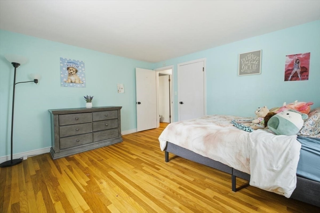 100 Whiting Street Hingham, MA 02043 - Photo 29 of 34 a bedroom with a bed and wooden floor