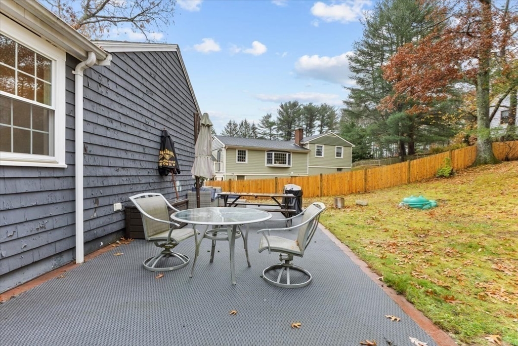 100 Whiting Street Hingham, MA 02043 - Photo 31 of 34 a view of a patio with table and chairs and wooden fence