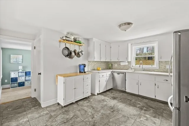 a kitchen with a white cabinets and refrigerator