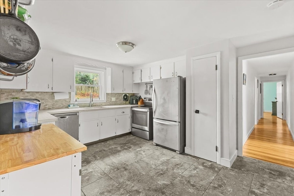 100 Whiting Street Hingham, MA 02043 - Photo 9 of 34 a kitchen with white cabinets and white appliances