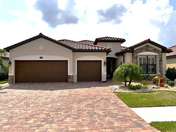 a front view of a house with a yard and garage