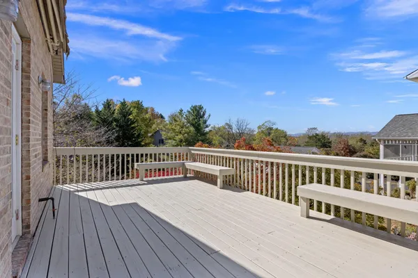 a view of a wooden deck with a yard
