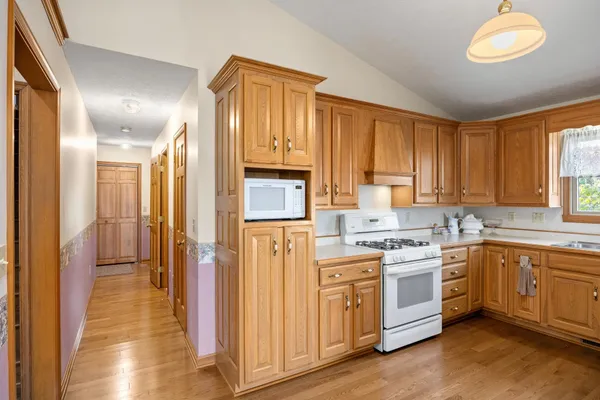 a kitchen with a sink cabinets and wooden floor