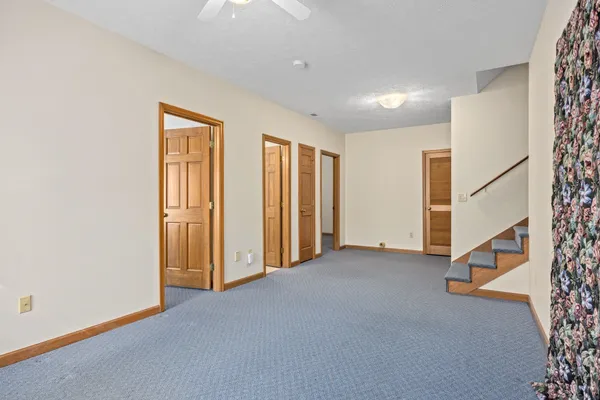 a view of an empty room with wooden floor and entryway