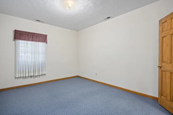 a bathroom with a sink a toilet a mirror and shower