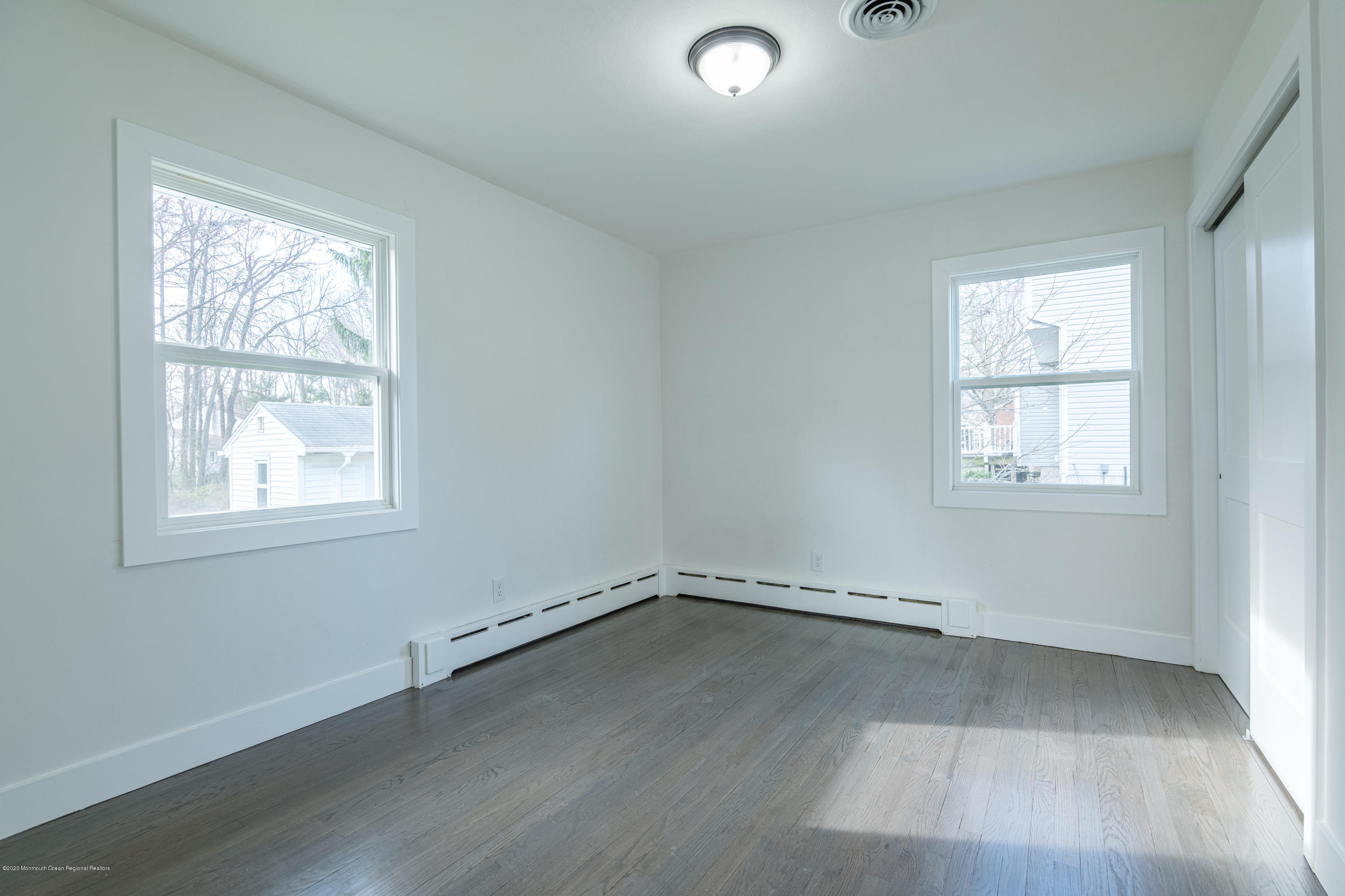 15 Johnson Road Lawrence Township, NJ 08648 - Photo 19 of 39 an empty room with wooden floor and windows