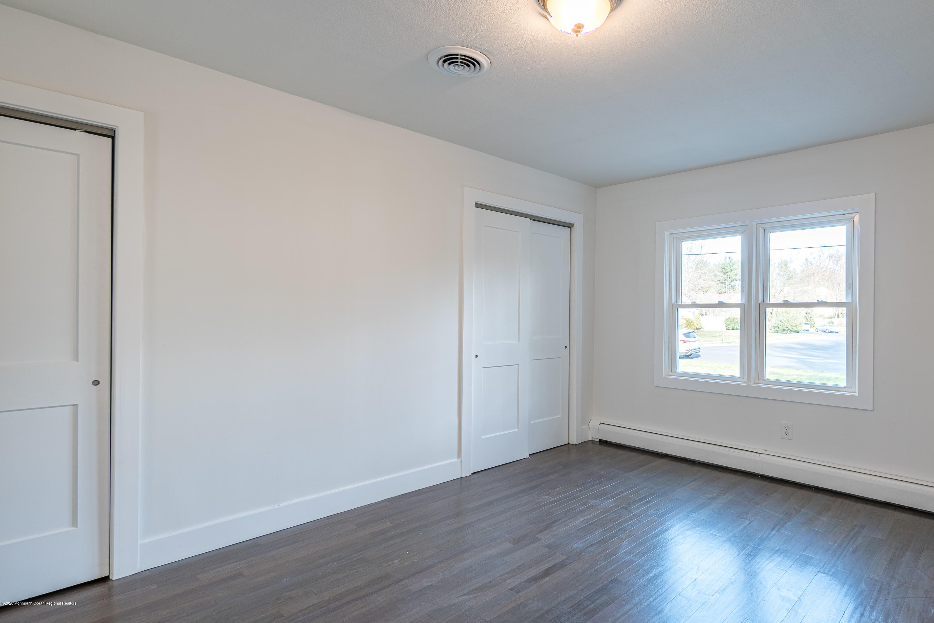 15 Johnson Road Lawrence Township, NJ 08648 - Photo 24 of 39 an empty room with wooden floor and windows