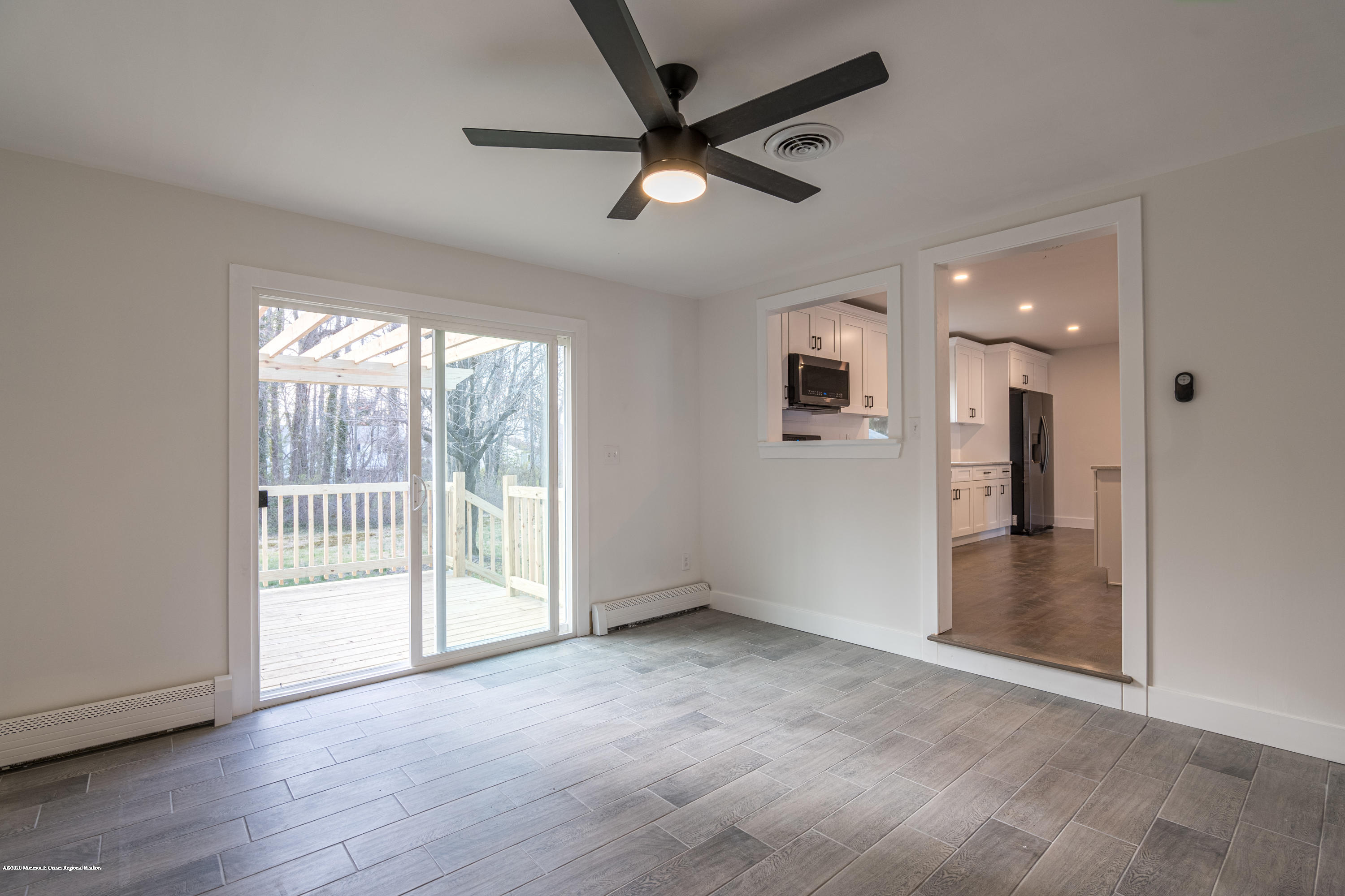 15 Johnson Road Lawrence Township, NJ 08648 - Photo 27 of 39 an empty room with wooden floor and a ceiling fan