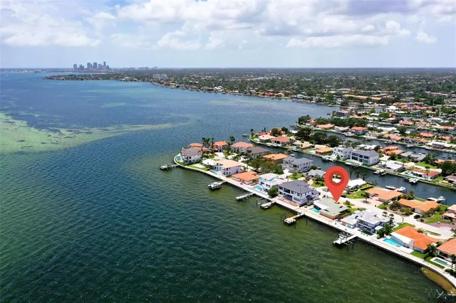 a living room with lots of furniture and a kitchen view
