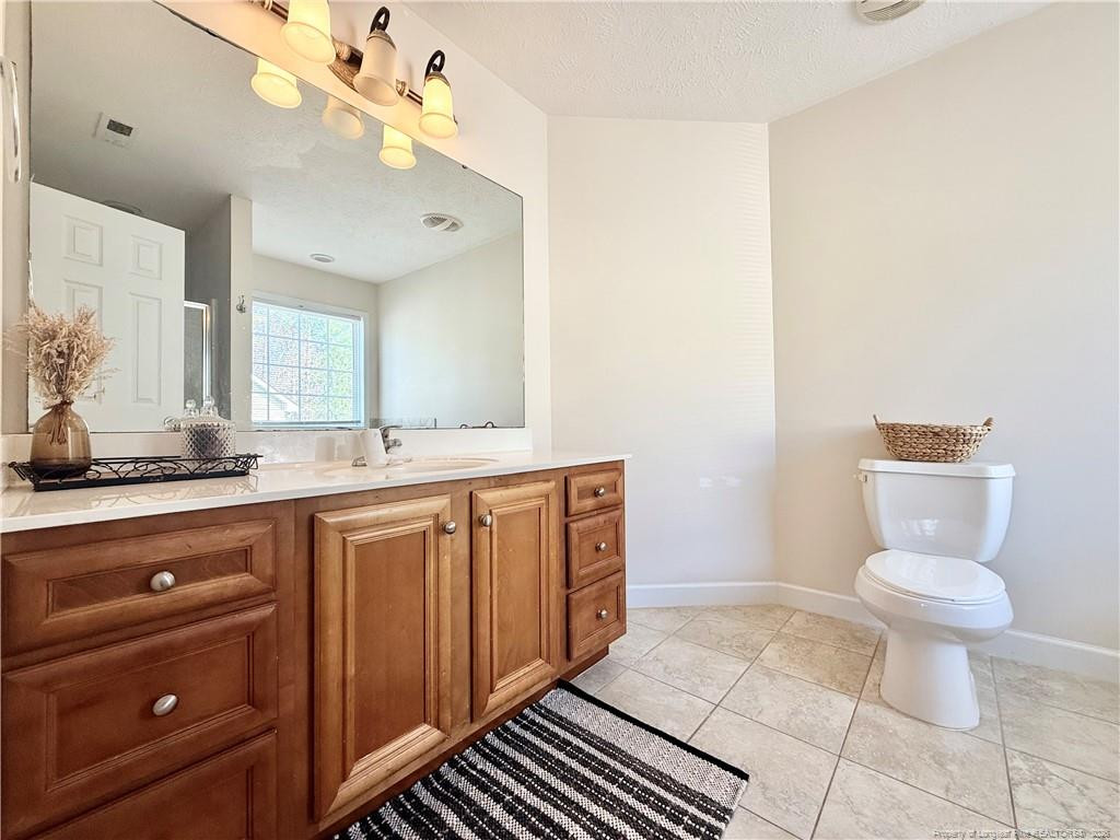 234 Pender Road Spring Lake, NC 28390 - Photo 30 of 39 a bathroom with a sink a toilet and a mirror