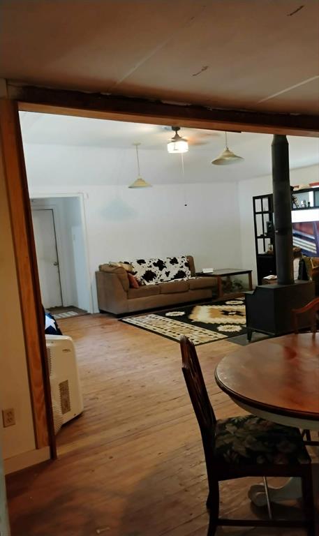 763 Frontier Street Bowie, TX 76230 - Photo 22 of 28 a dining room with furniture and wooden floor