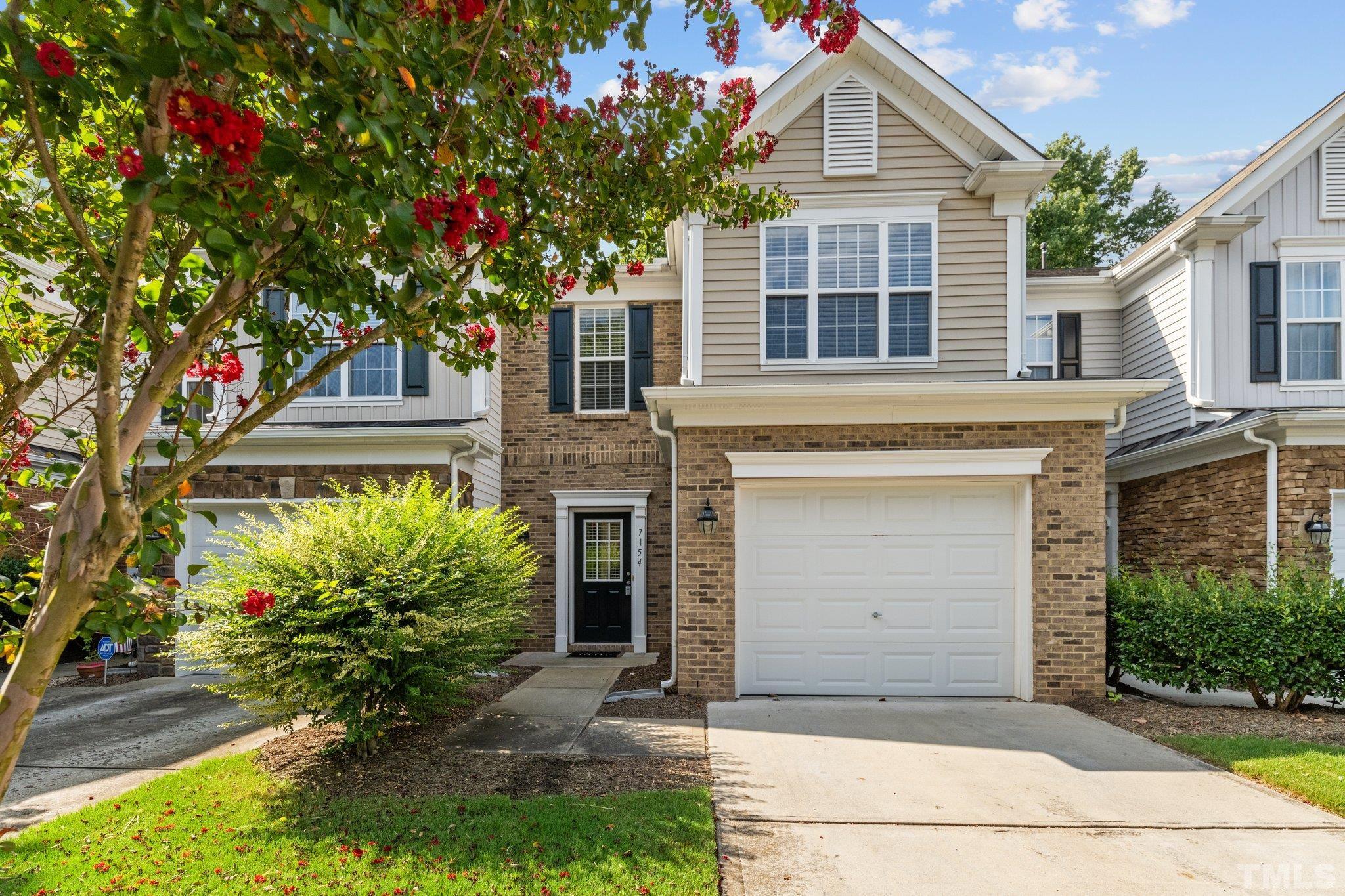 7154 Racine Way Raleigh, NC 27615 - Photo 1 of 31 a front view of a house with a garden