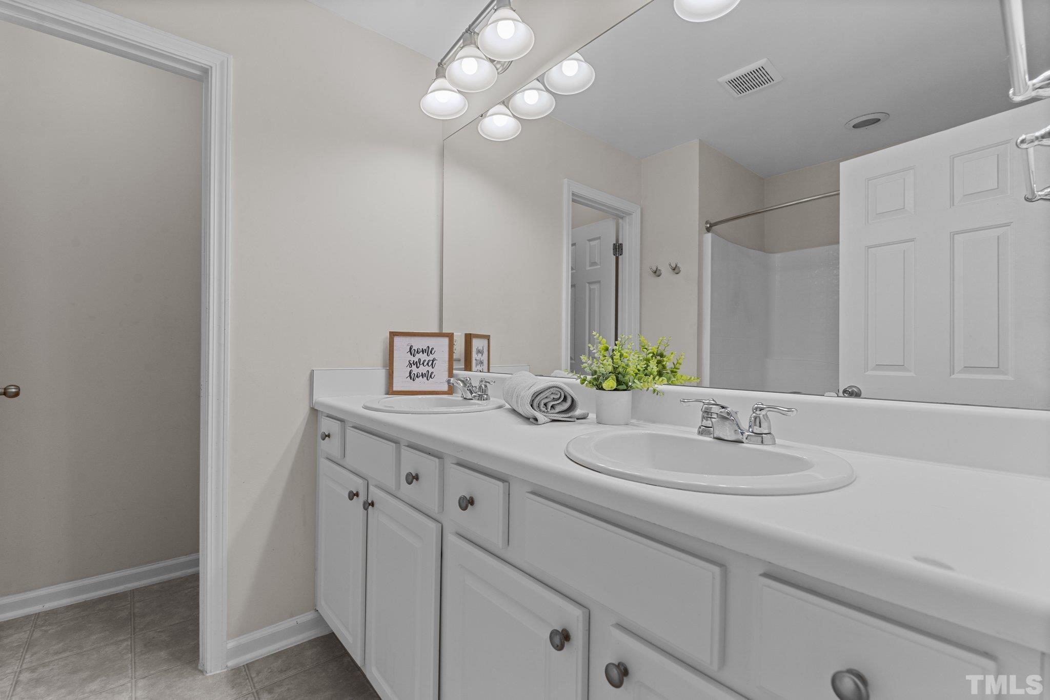 7154 Racine Way Raleigh, NC 27615 - Photo 17 of 31 a bathroom with a sink and a mirror