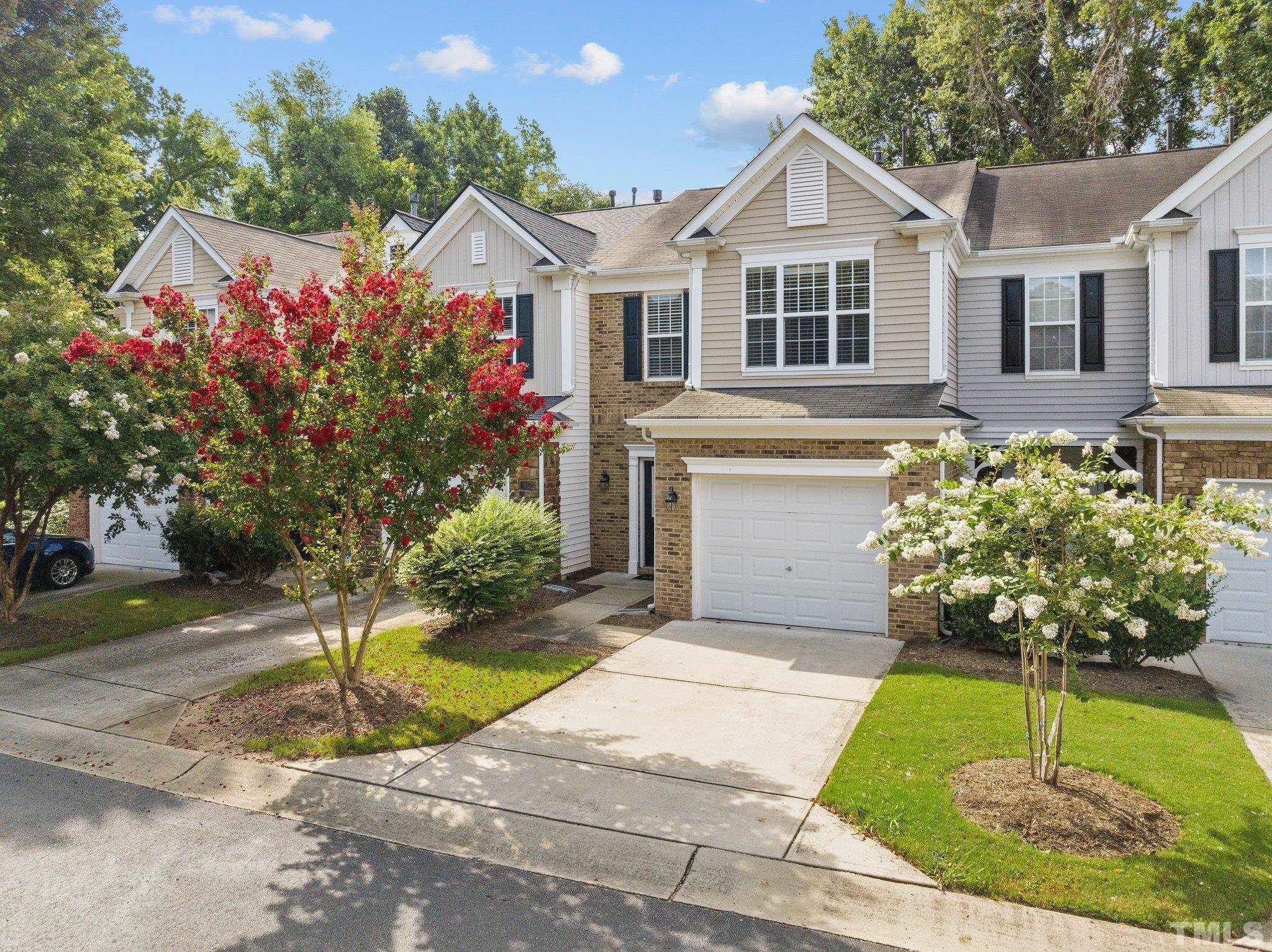 7154 Racine Way Raleigh, NC 27615 - Photo 3 of 31 a front view of a house with a yard and a porch