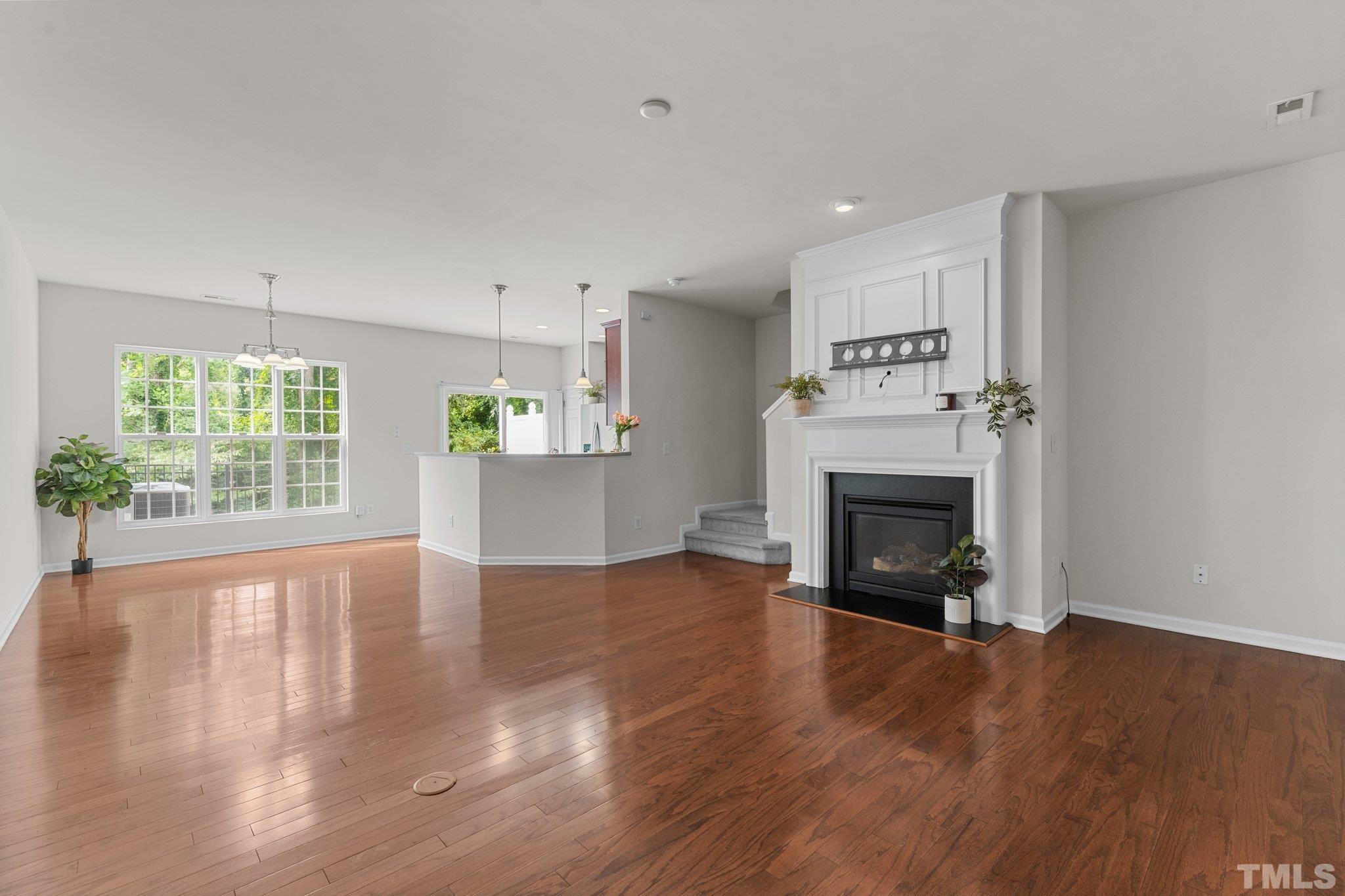 7154 Racine Way Raleigh, NC 27615 - Photo 8 of 31 a view of an empty room with wooden floor and a window