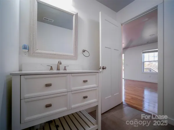 a bathroom with a sink vanity and mirror