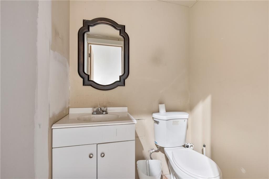 3208 Smallman Street Pittsburgh, PA 15201 - Photo 14 of 17 a bathroom with a toilet sink and mirror