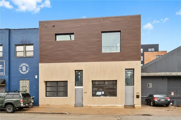 a view of building with car parked