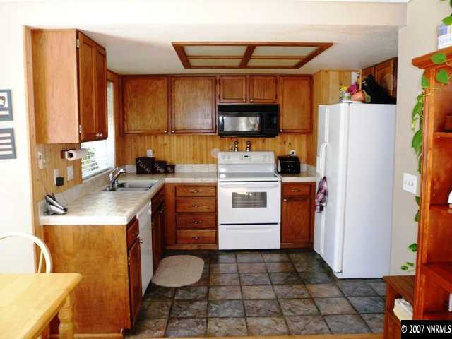 4030 Desoto Way Reno, NV 89502 - Photo 4 of 9 a kitchen with a sink a stove and a refrigerator