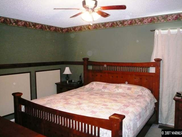 4030 Desoto Way Reno, NV 89502 - Photo 7 of 9 a bed sitting in a bedroom next to a window