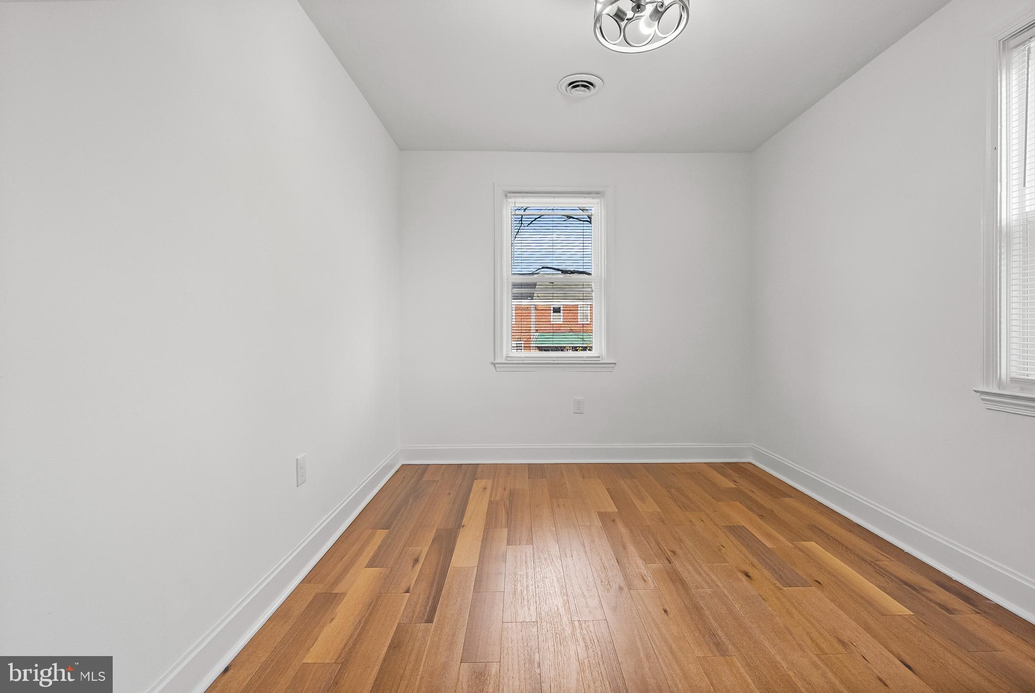 5814 Falkirk Road Baltimore, MD 21239 - Photo 12 of 32 a view of a room with wooden floor and window