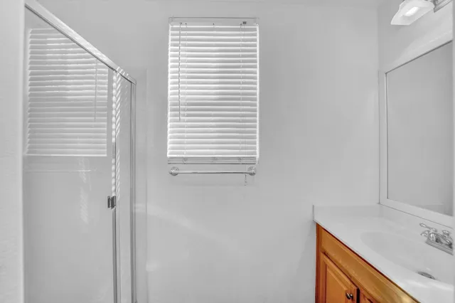 a view of a hallway with wooden shelves